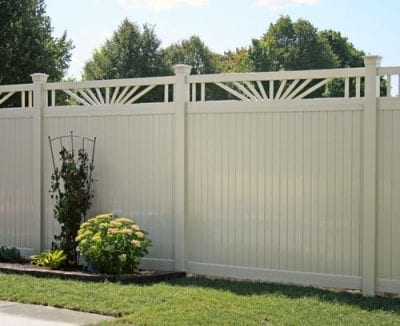 Tall white privacy fence with view of small garden