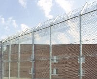 Tall chain link fence with bob wire at the top