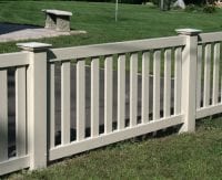 Short white fence by driveway