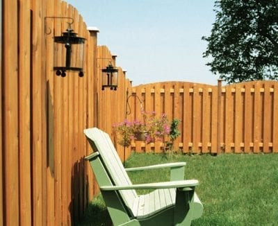 Wood fence with view of cottage chair