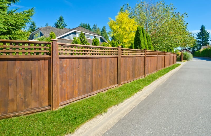 Solid board fence surrounding home for privacy