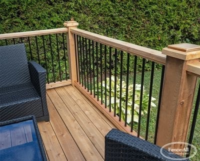 wood railing w/3/4″ round metal pickets on wrapped posts