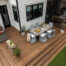 Large modern backyard deck with integrated outdoor dining area and multi-level wood decking attached to a contemporary home.