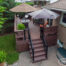 Custom elevated deck with decorative black aluminum railings, combining style, safety, and backyard functionality for outdoor living.