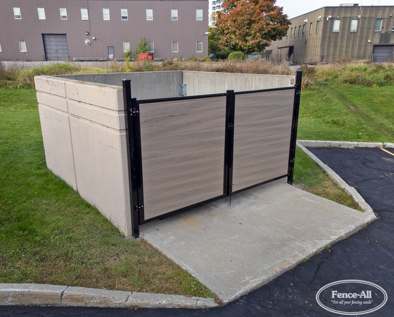 Vinyl backyard storage enclosure designed to conceal garbage and recycling bins while matching a privacy fence.