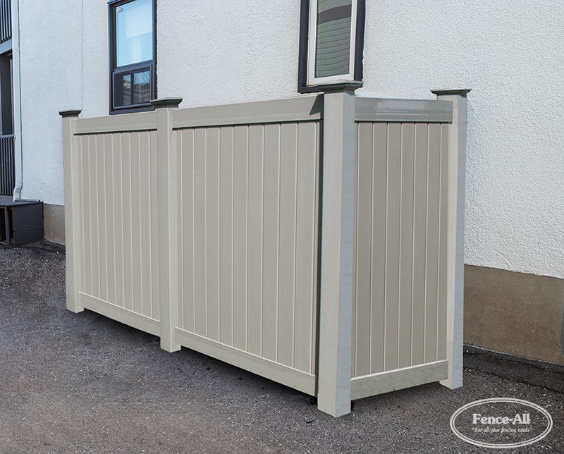 Modern backyard garbage and recycling bin enclosure with wood-look privacy panels installed by Fence-All.